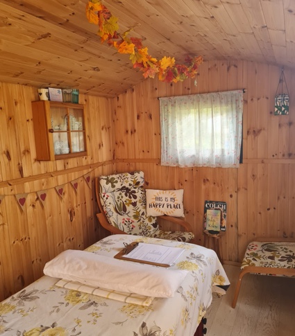 Inside shepherds rest hut with delicate autumnal decorations hanging from the roof