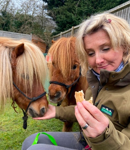 Photograph of Natasha feeding two ponies